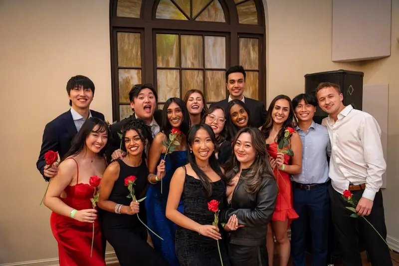 A group of brothers holding roses at the 10th Annual Banquet