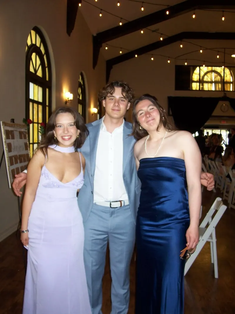 Three brothers in formal wear in the Banquet 2025 hall