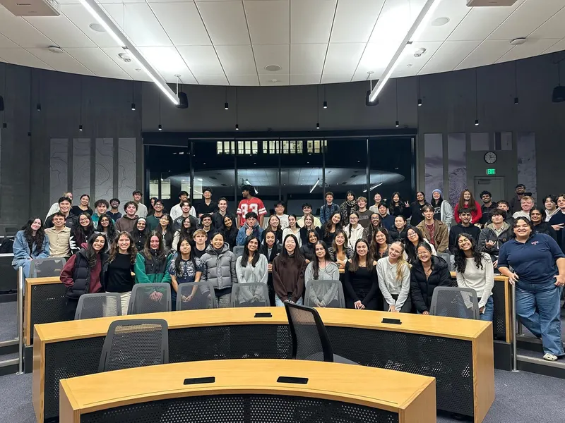 A large group of brothers filling a lecture hall at a chapter meeting