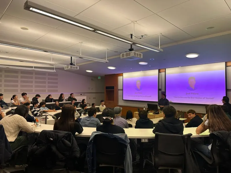 A full lecture hall listening to a speaker presentation